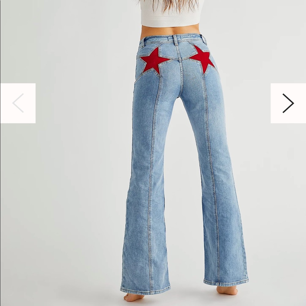 Free People LIKE NEW Jeans with red suede stars on back.  At FPeople for $168.